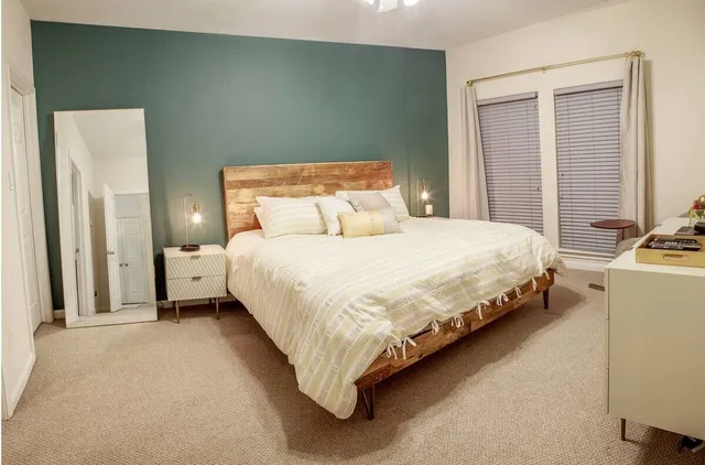 a bedroom with bed and window