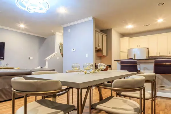 a kitchen with a dining table and chairs