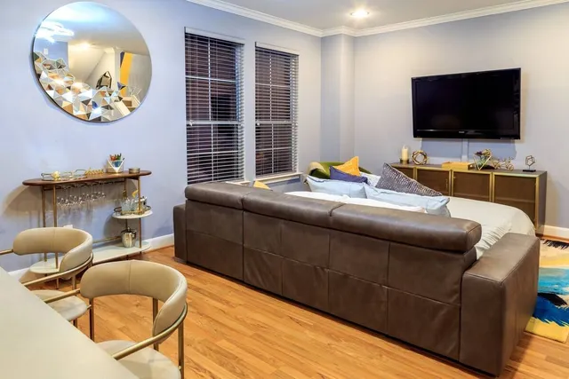 a living room with furniture and a flat screen tv
