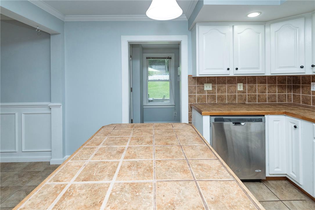 280 Oak Road Bangor, PA 18013 - Photo 9 of 52 Tiled countertops and white cabinetry define this functional kitchen workspace.