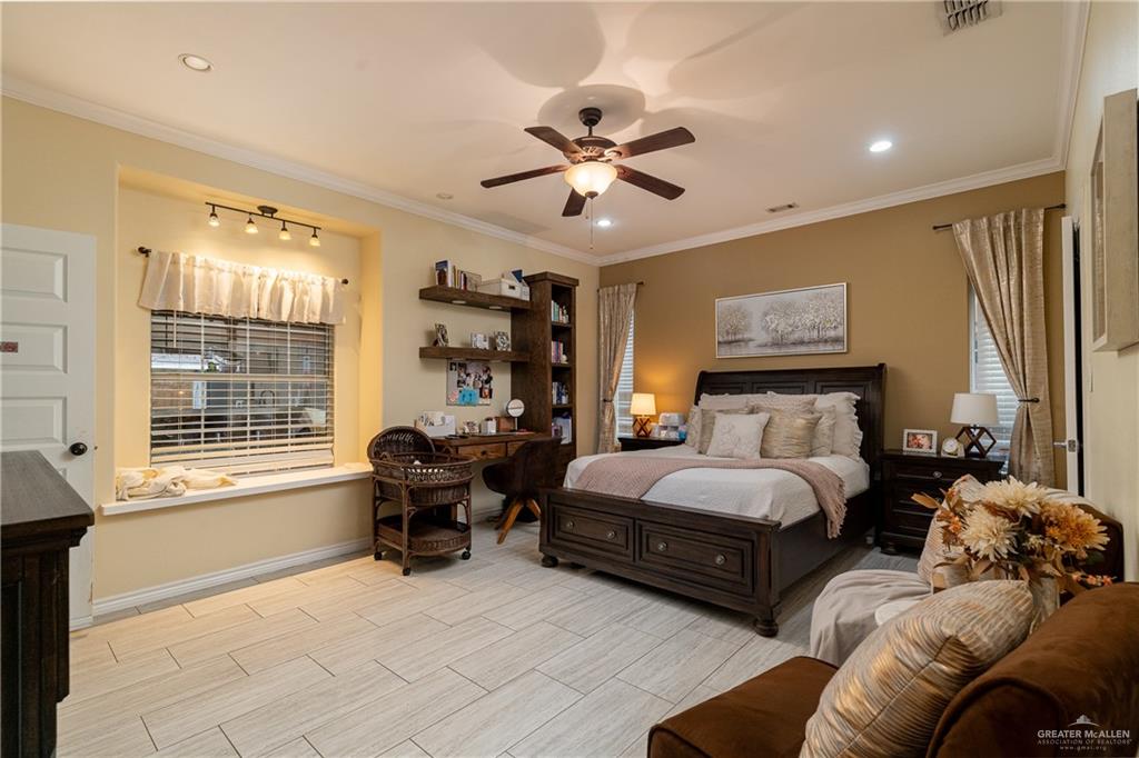 701 West Falcon Avenue Pharr, TX 78577 - Photo 13 of 24 a spacious bedroom with a bed and glass window
