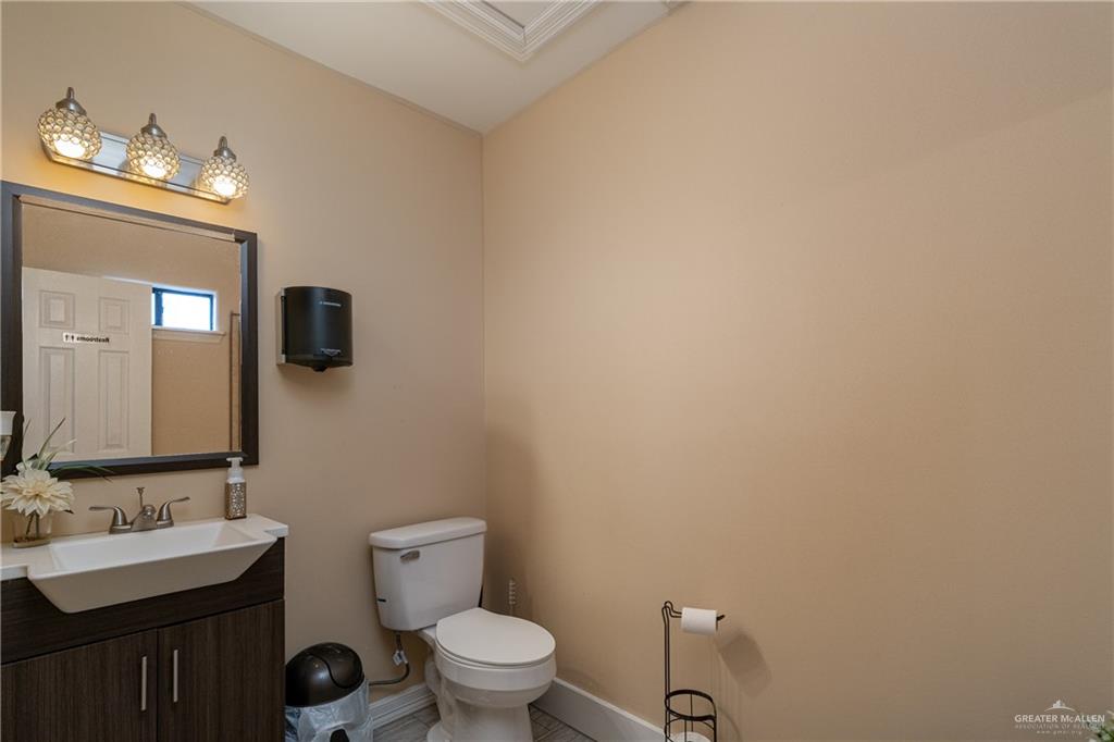 701 West Falcon Avenue Pharr, TX 78577 - Photo 16 of 24 a bathroom with a toilet a sink and mirror