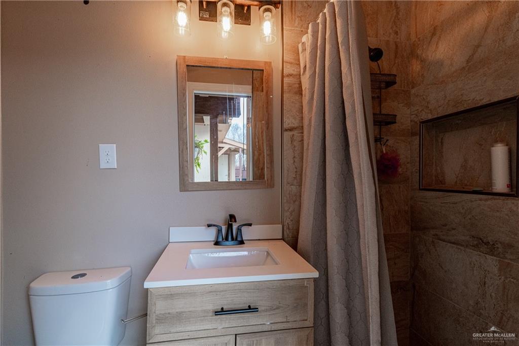 701 West Falcon Avenue Pharr, TX 78577 - Photo 20 of 24 a bathroom with a sink a toilet and a mirror