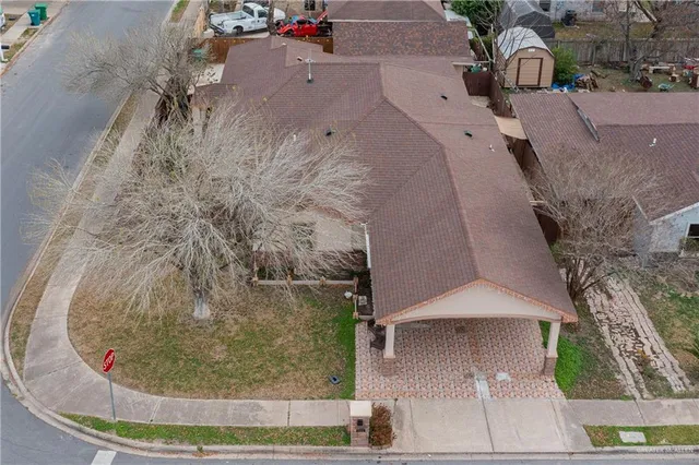 an aerial view of a house with a yard and pool