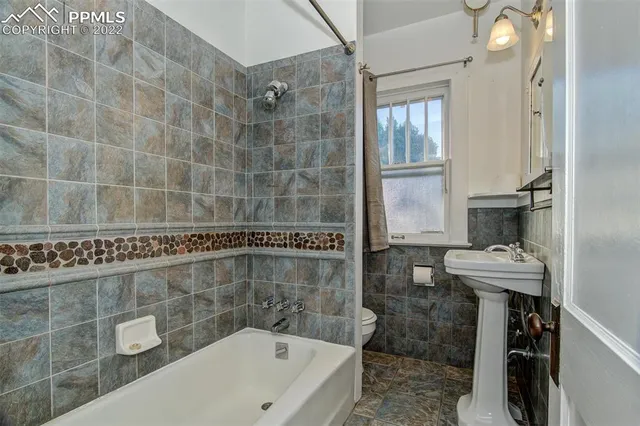 a bathroom with a bathtub and a sink