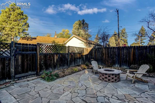a view of a outdoor sitting area with furniture and wooden fence