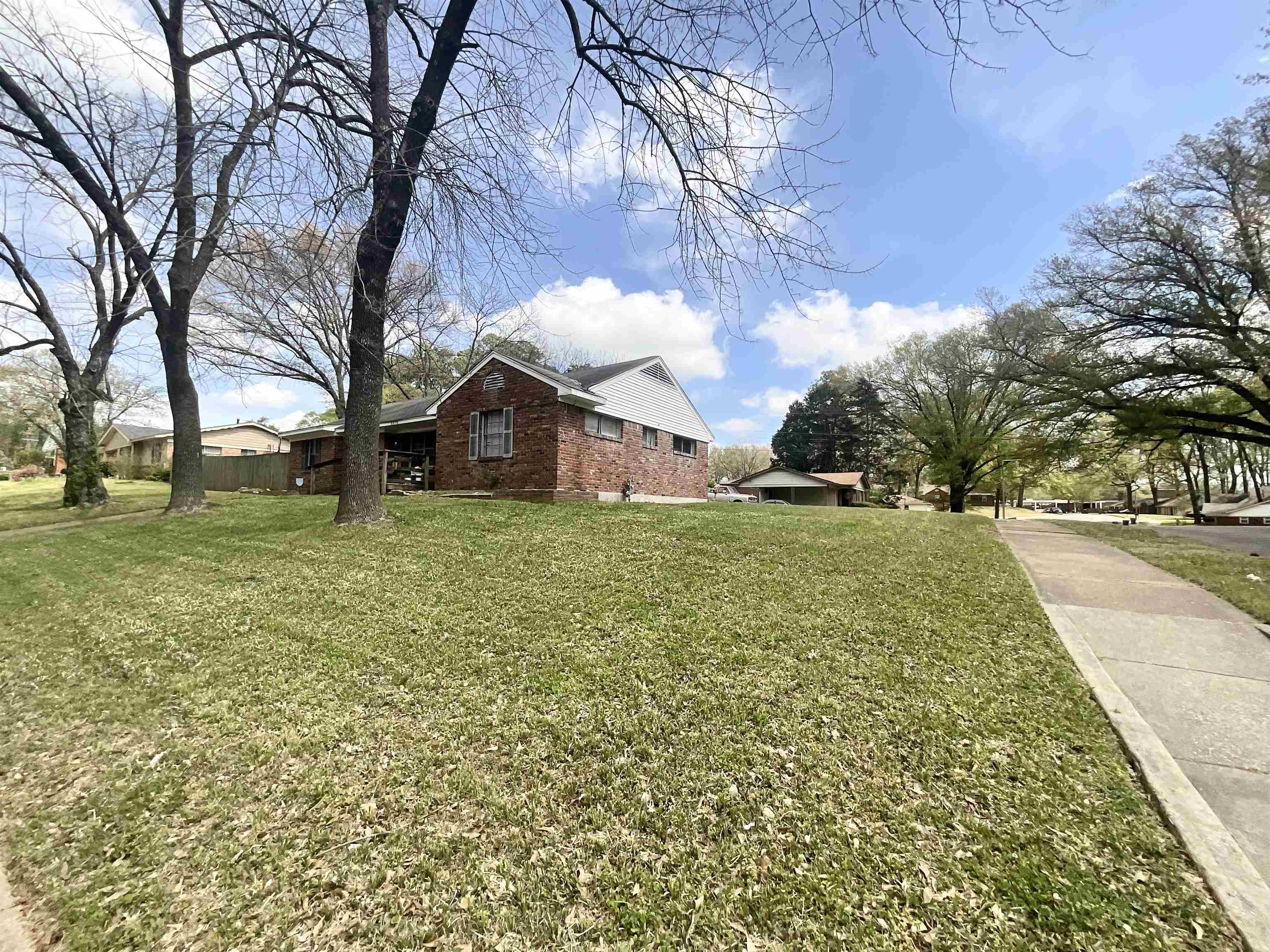 3370 Debby Street Memphis, TN 38127 - Photo 3 of 8 a view of a yard with a house in the background