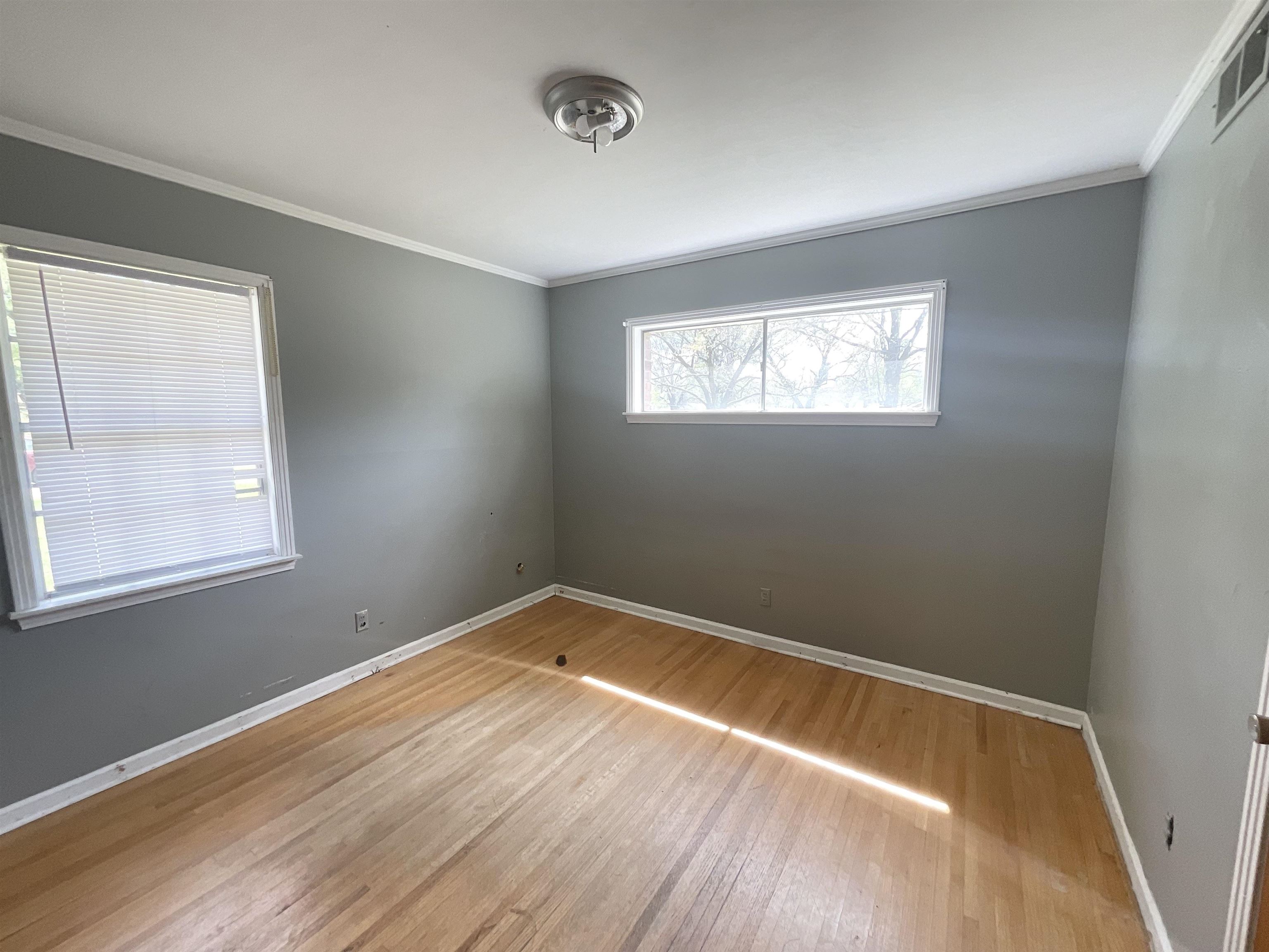 3370 Debby Street Memphis, TN 38127 - Photo 6 of 8 an empty room with wooden floor and windows