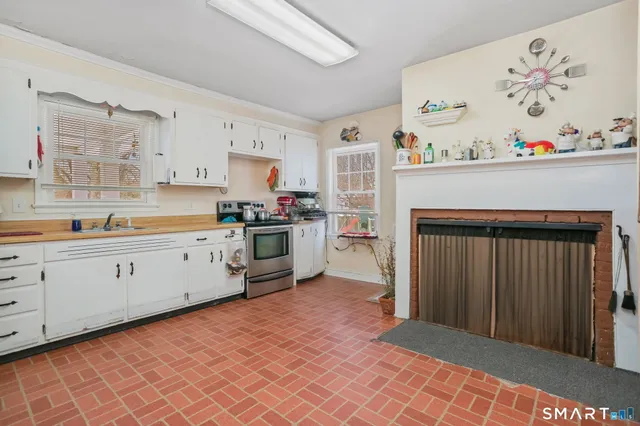 a kitchen with stainless steel appliances granite countertop a refrigerator sink and cabinets