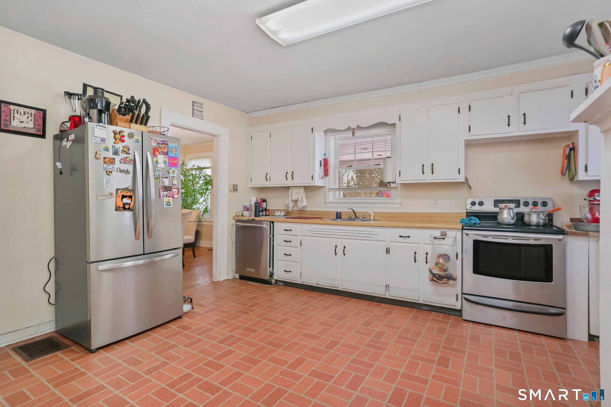 877 White Plains Road Trumbull, CT 06611 - Photo 12 of 33 a kitchen with stainless steel appliances a refrigerator sink and cabinets