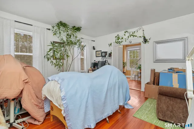 a bed room with a bed and a chair