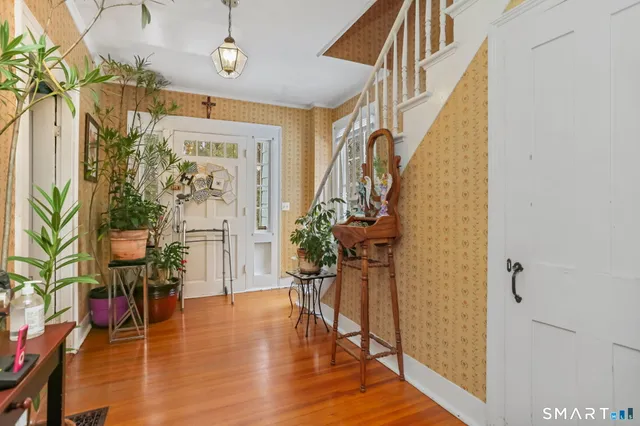 a view of a hallway with wooden floor