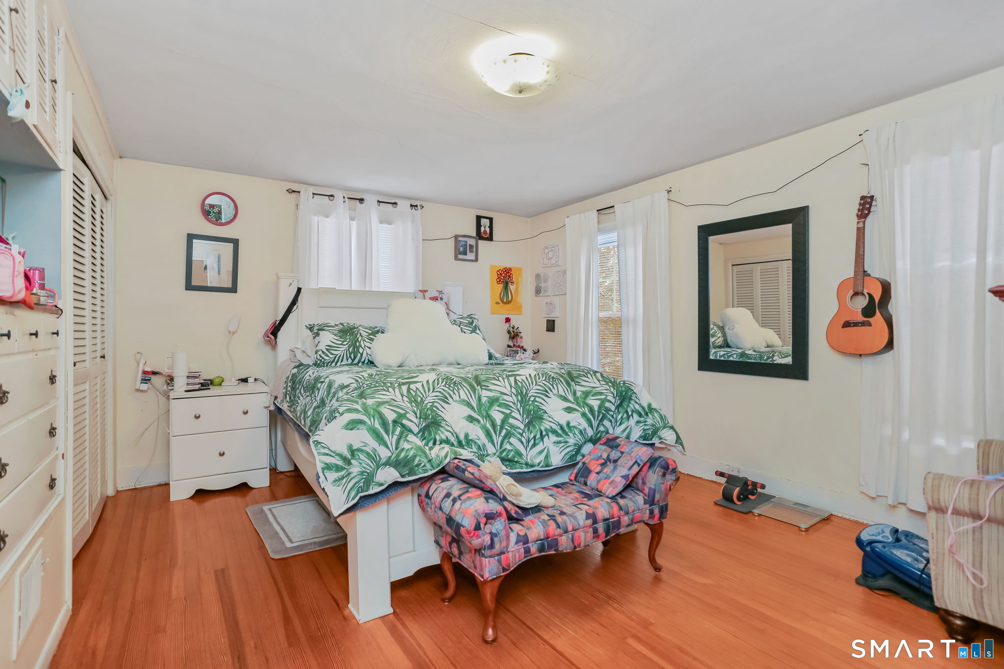 877 White Plains Road Trumbull, CT 06611 - Photo 25 of 33 a living room with furniture and painting on the wall next to a window