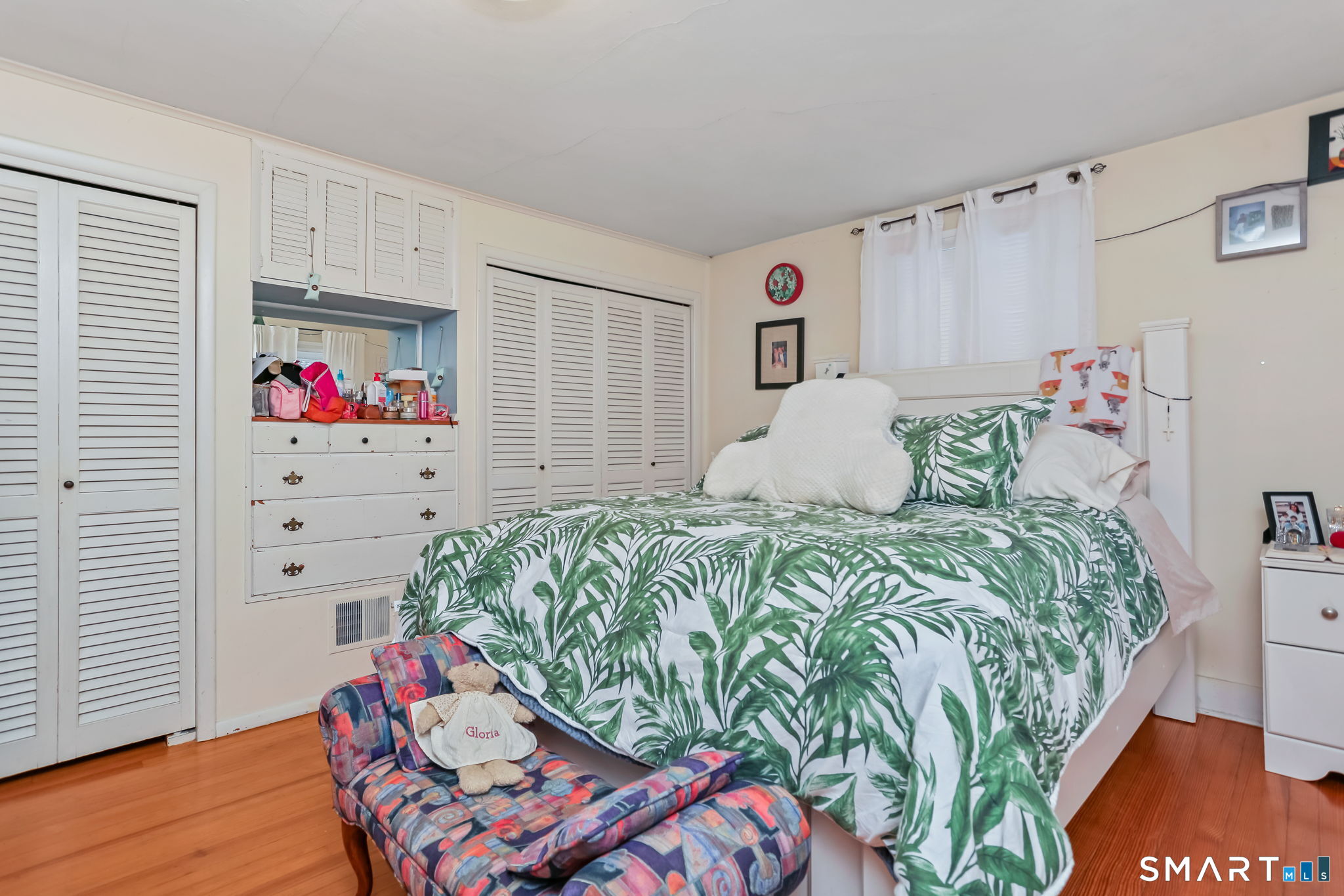 877 White Plains Road Trumbull, CT 06611 - Photo 26 of 33 a bedroom with a bed and wooden floor