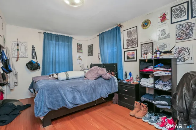 a bedroom that has a bed and a chair in it