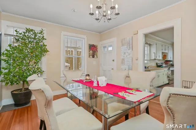 a view of a dining room with furniture and chandelier