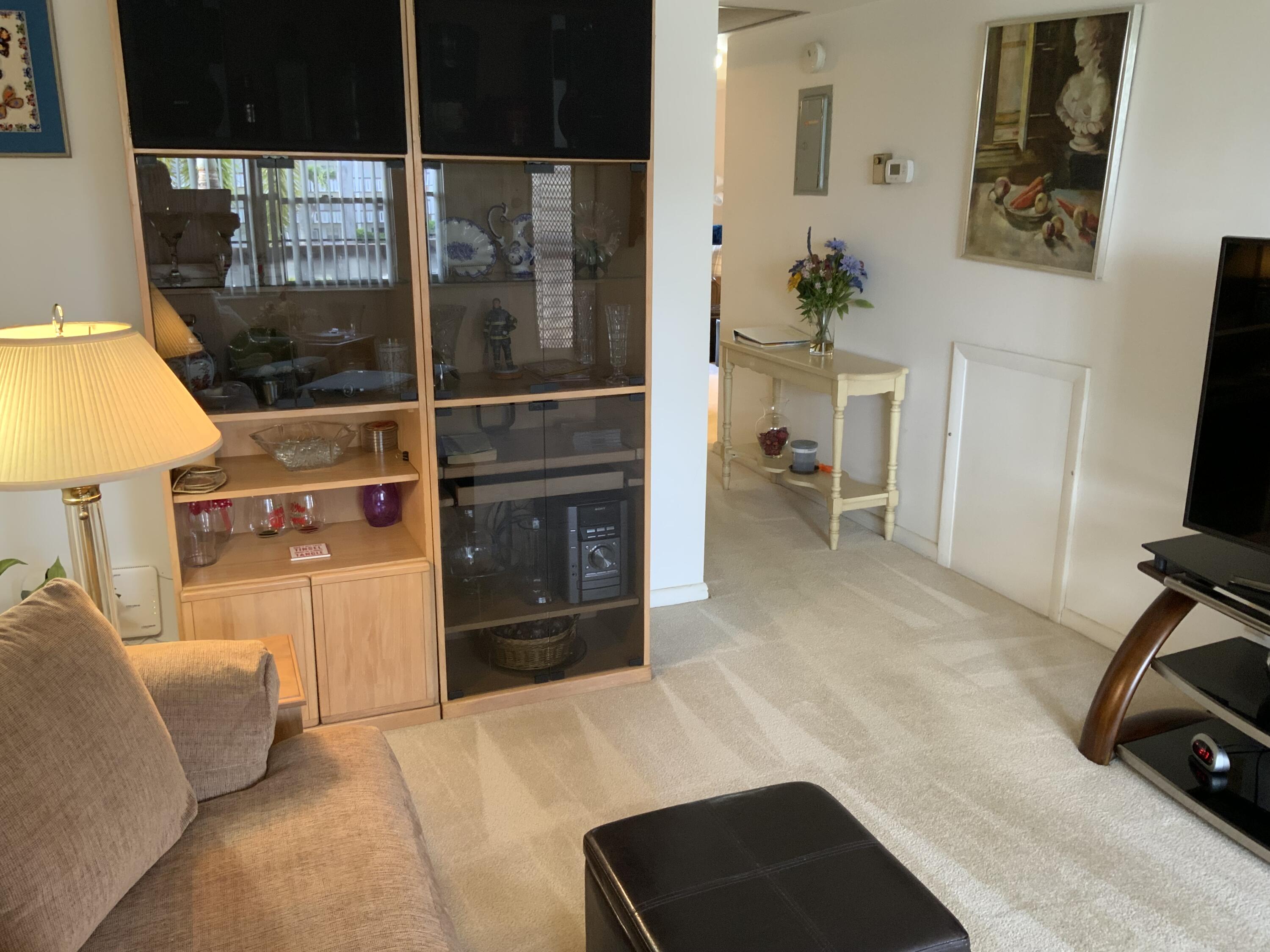 2050 Hythe A Boca Raton, FL 33434 - Photo 18 of 20 a living room with furniture a rug and a flat screen tv