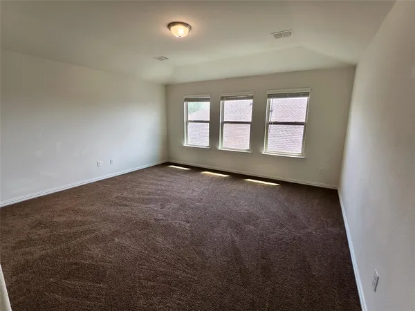an empty room with a windows