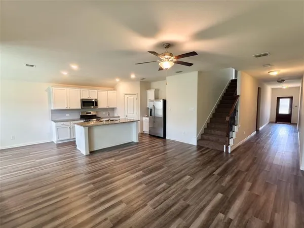 a view of kitchen with cabinets and wooden floor