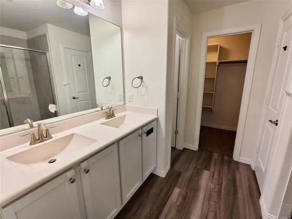 a bathroom with a double vanity sink and mirror