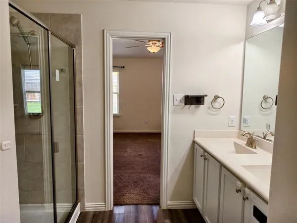 a bathroom with a sink a mirror and a shower