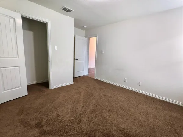 an empty room with closet area