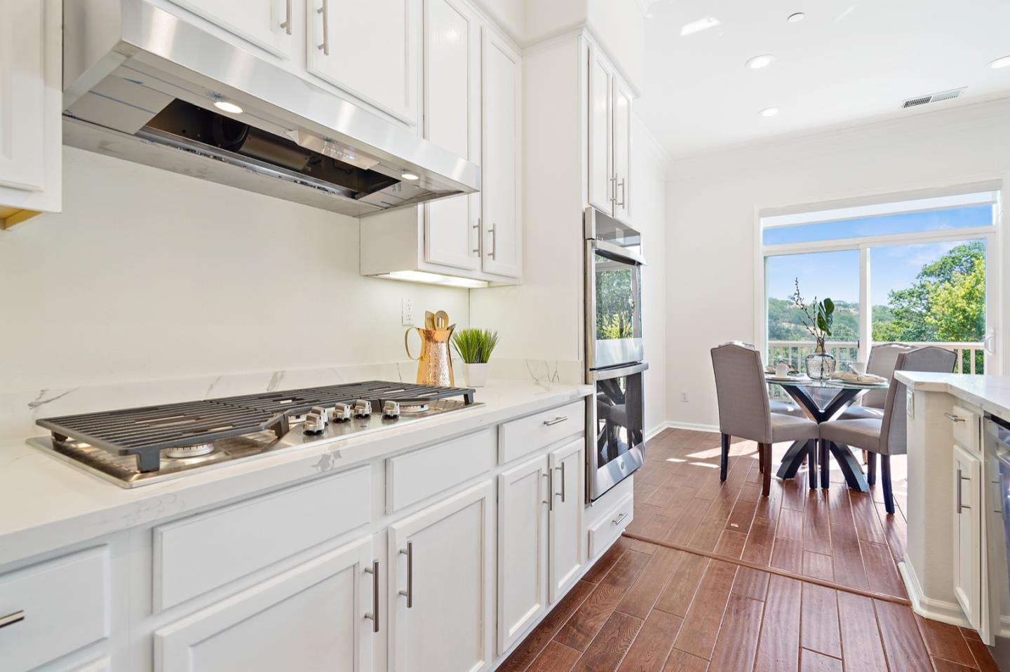 3066 Grey Eagle Drive Walnut Creek, CA 94595 - Photo 3 of 47 a kitchen with stainless steel appliances granite countertop a stove a sink dishwasher and white cabinets with wooden floor