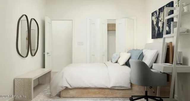a large white bed sitting in a bedroom next to a window