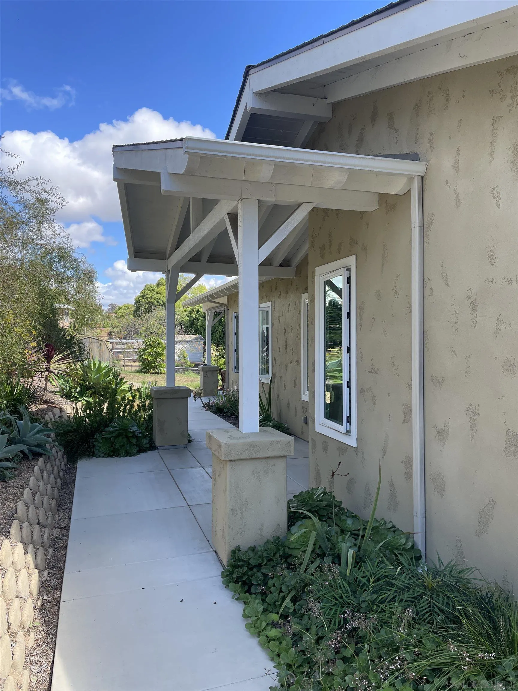 327 Cole Ranch Road Encinitas, CA 92024 - Photo 3 of 22 a view of a patio with table and chairs potted plants with floor to ceiling window