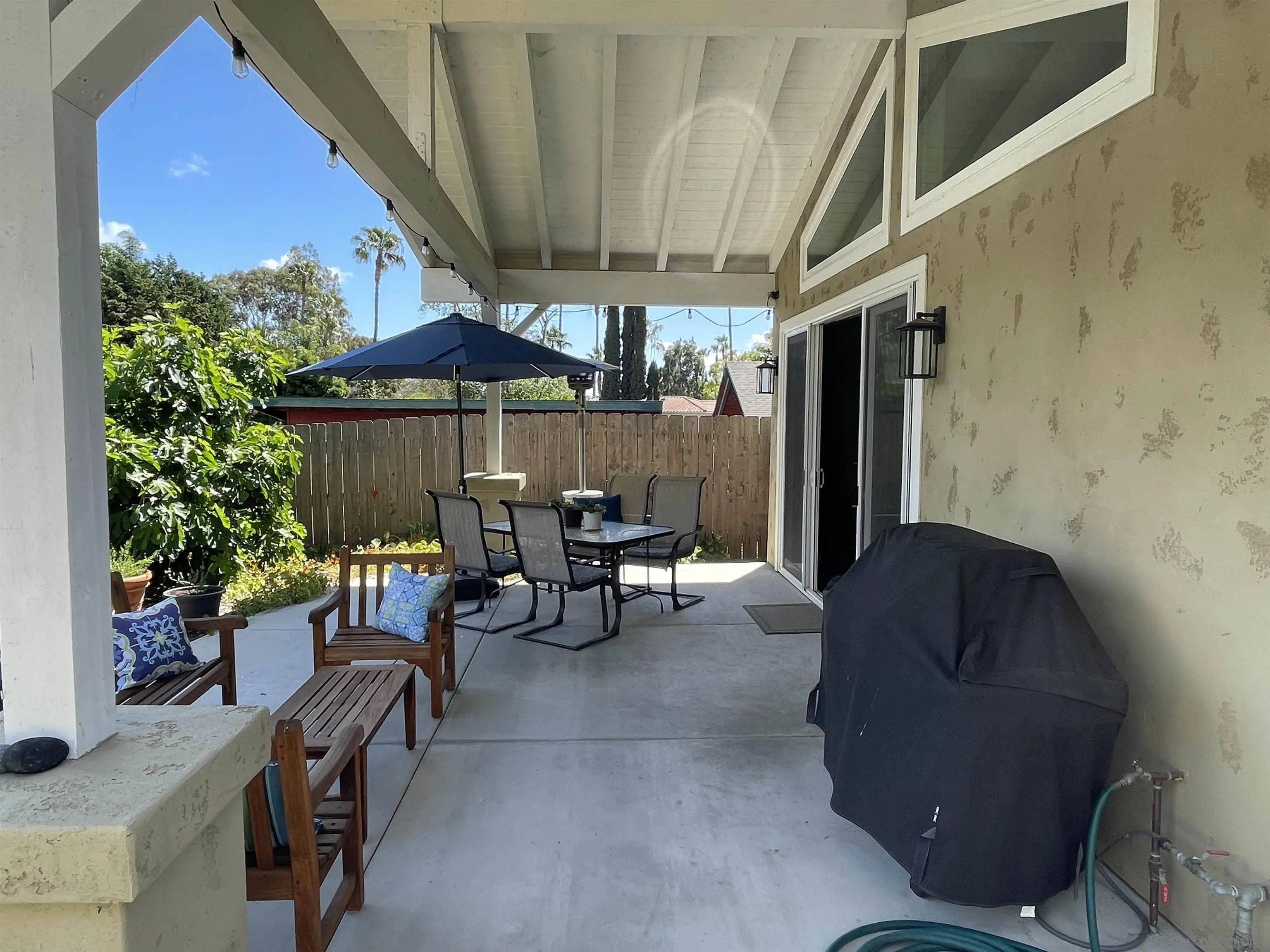 327 Cole Ranch Road Encinitas, CA 92024 - Photo 4 of 22 a balcony with furniture and umbrella