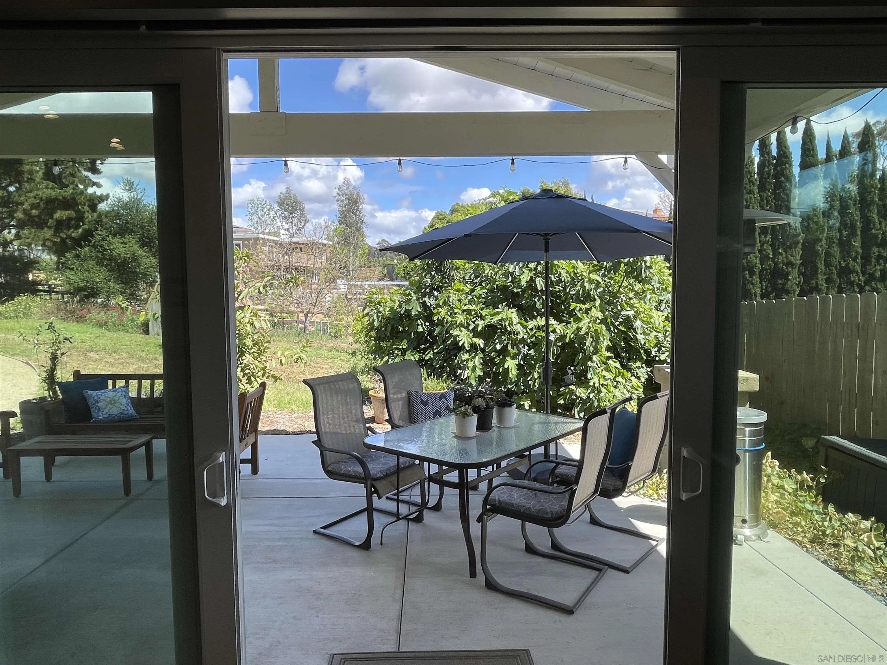327 Cole Ranch Road Encinitas, CA 92024 - Photo 5 of 22 a view of a patio with table and chairs under an umbrella