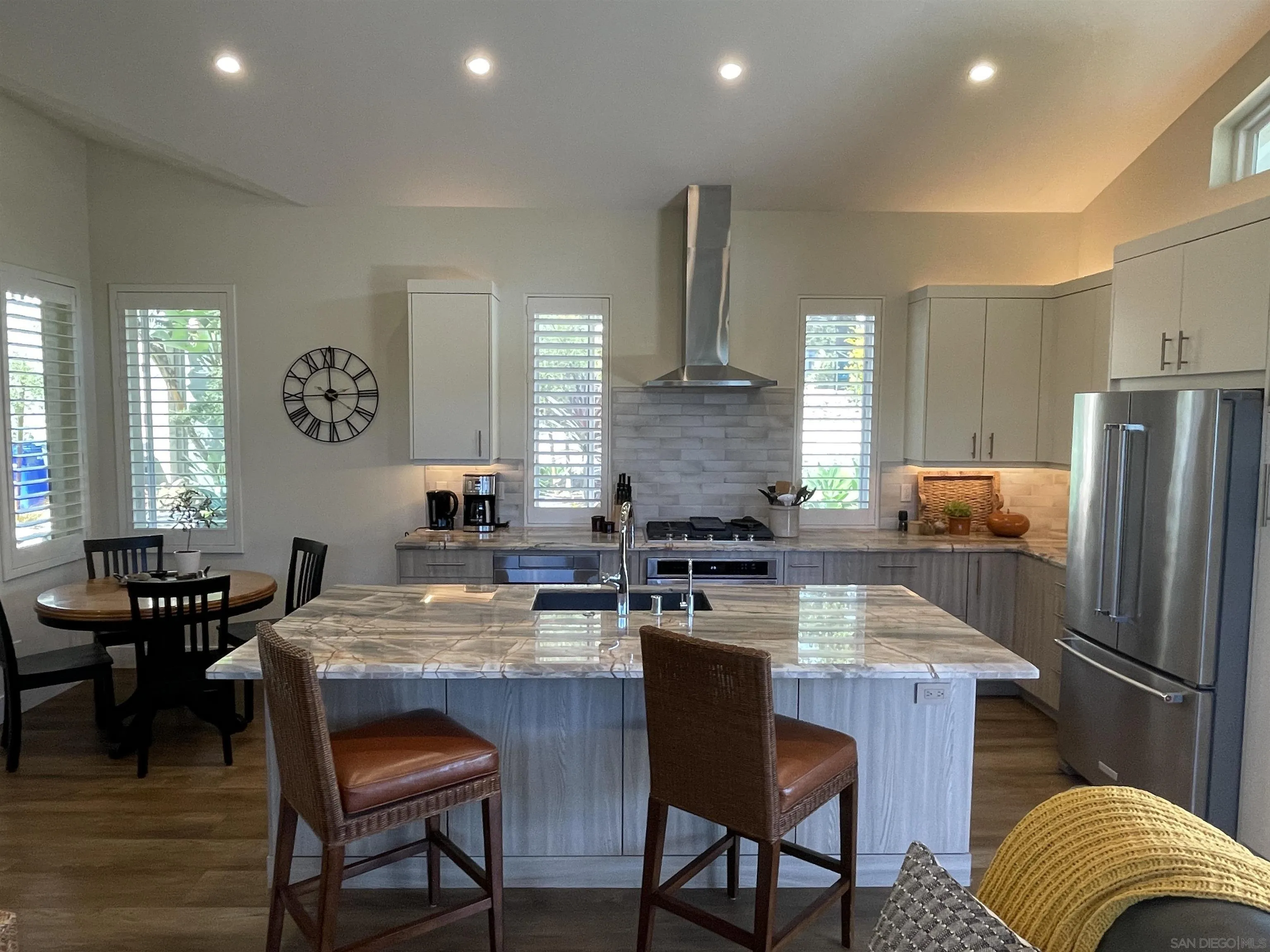 327 Cole Ranch Road Encinitas, CA 92024 - Photo 8 of 22 a kitchen with granite countertop kitchen island stainless steel appliances a table and chairs
