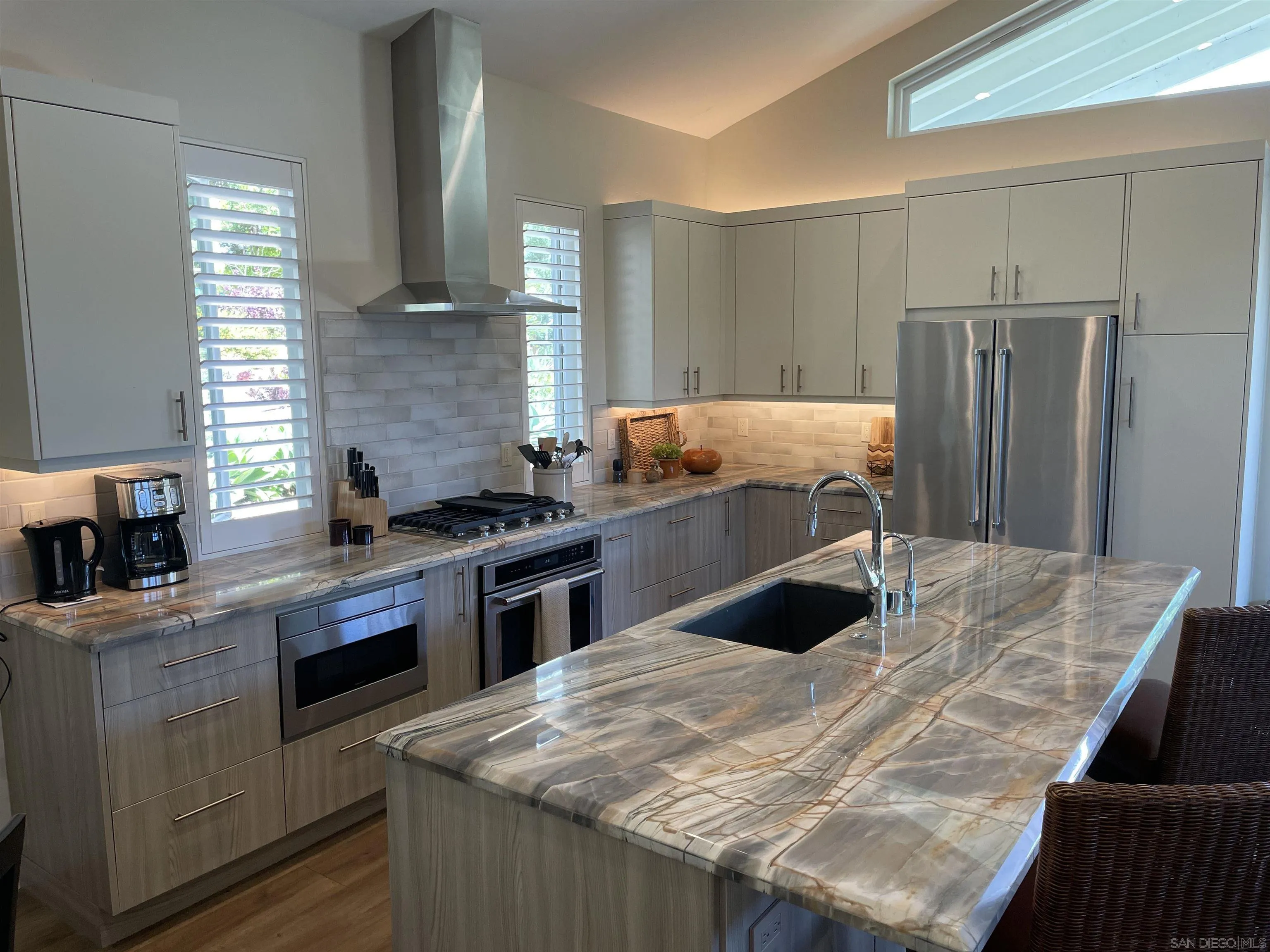 327 Cole Ranch Road Encinitas, CA 92024 - Photo 10 of 22 a kitchen with kitchen island granite countertop a sink stove and refrigerator
