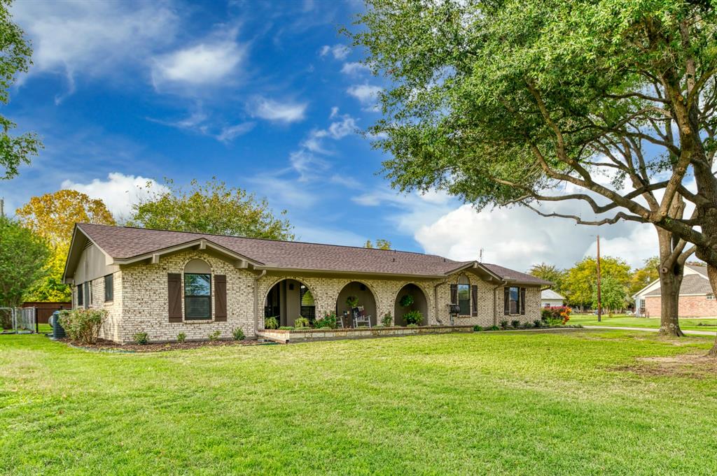 a front view of house with yard and trees