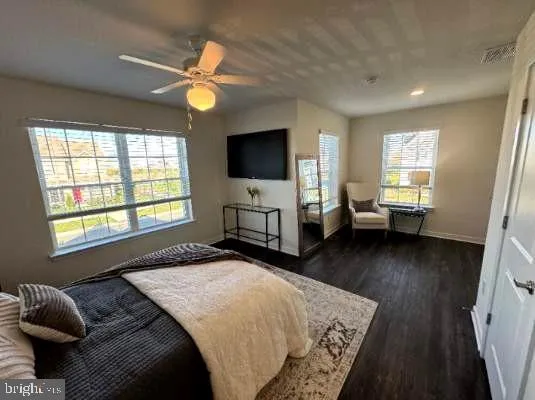 a bedroom with a bed window and a flat screen television