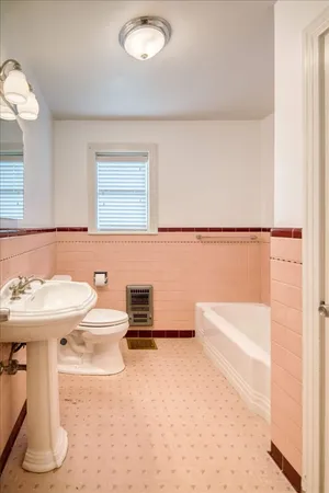 a bathroom with a sink a toilet and bathtub