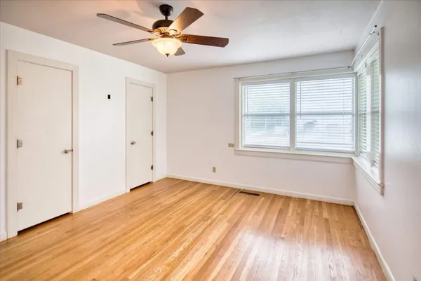 wooden floor in an empty room with a window