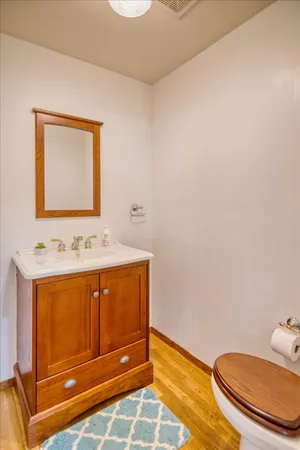 a bathroom with a sink a toilet and mirror