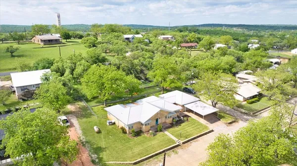 an aerial view of residential houses with outdoor space and street view