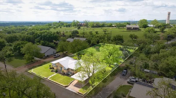 an aerial view of a house with a yard