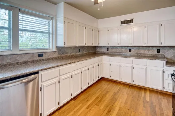 a kitchen with sink cabinets and window