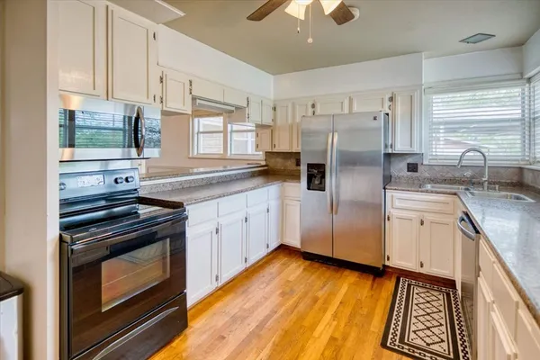 a kitchen with a stove a sink and a refrigerator