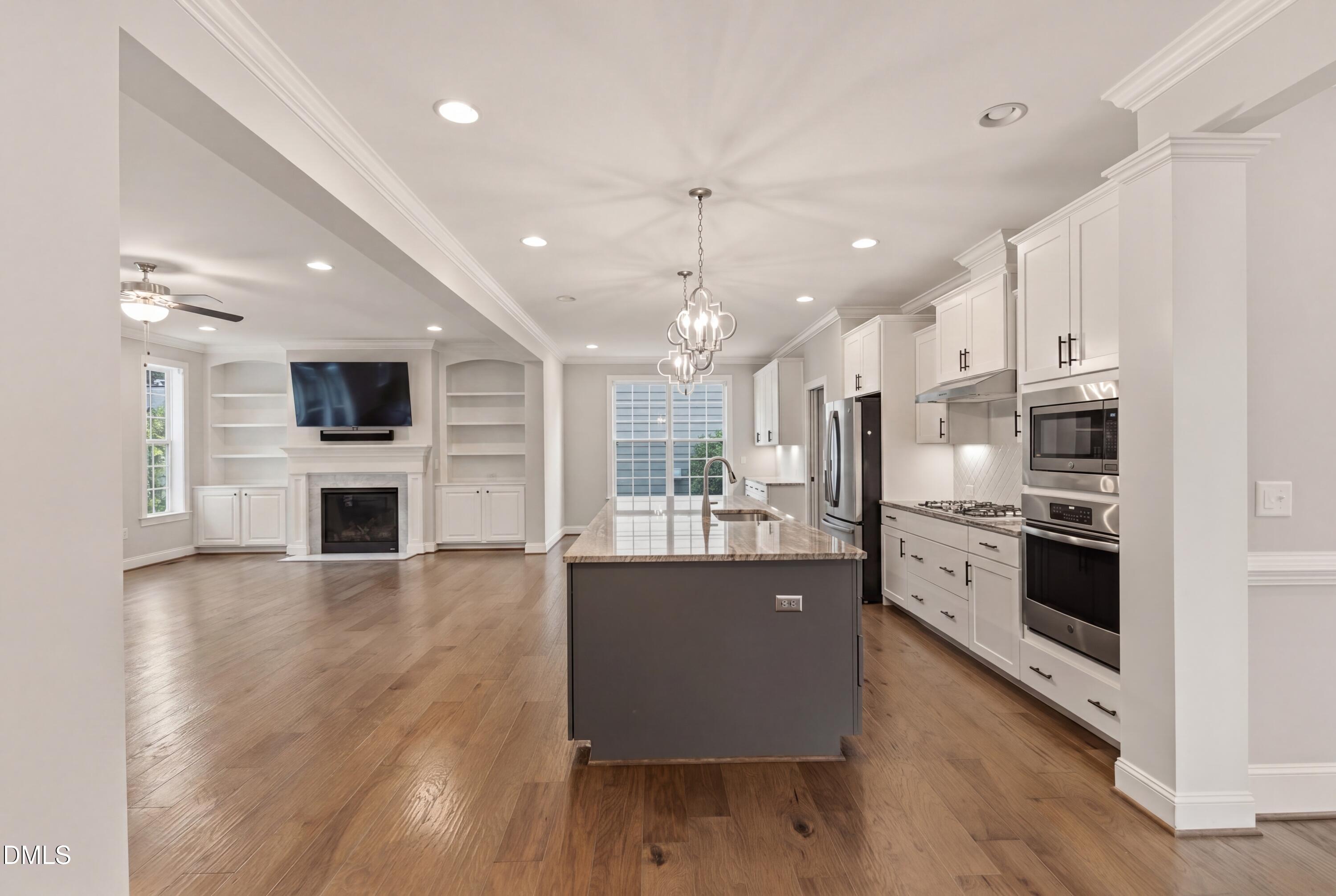 7421 Stonehenge Farm Lane Raleigh, NC 27613 - Photo 47 of 48 a large kitchen with stainless steel appliances kitchen island a large counter top and a refrigerator