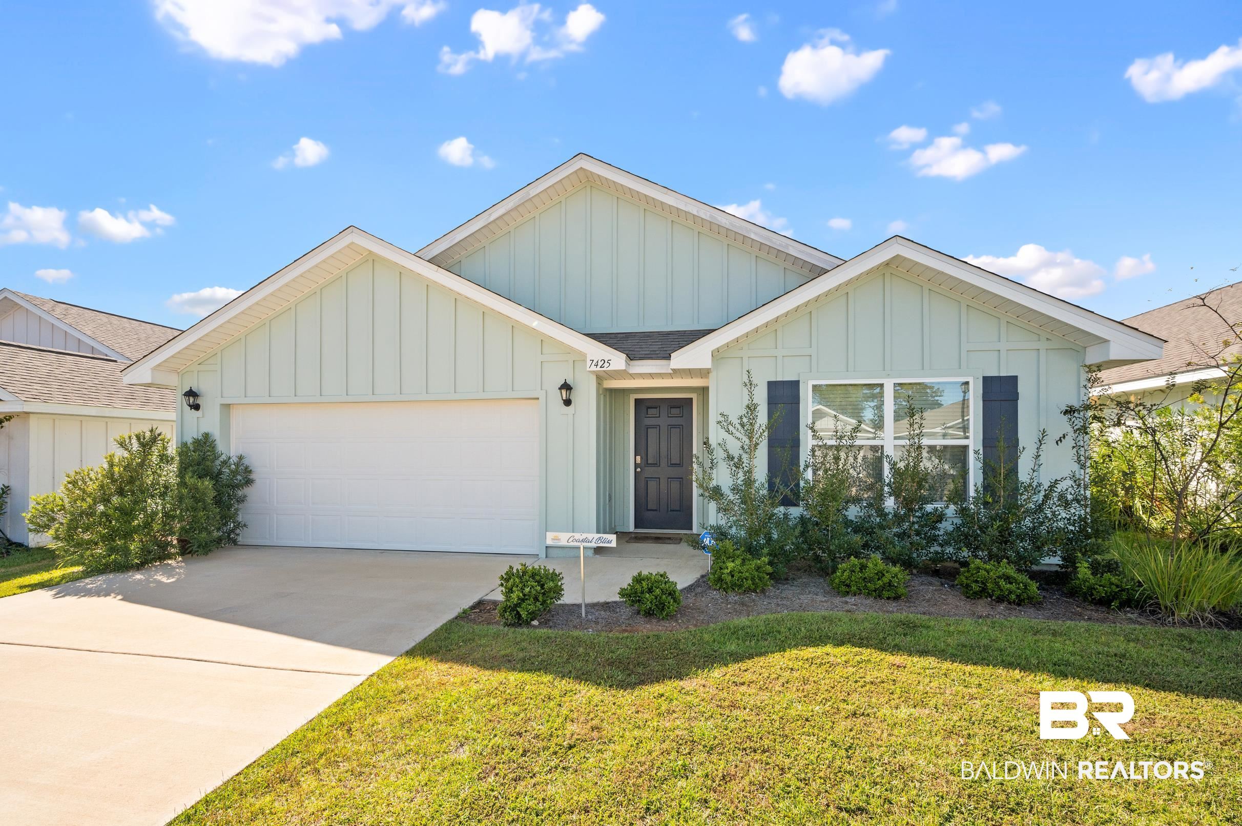7425 Coppin Drive Foley, AL 36535 - Photo 2 of 41 View of front facade with a front lawn and a garage