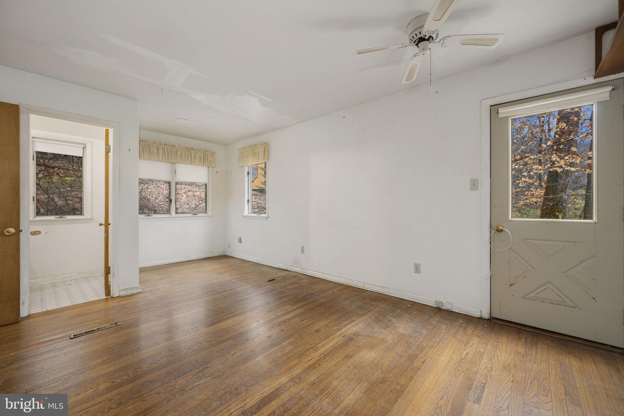 230 Jug Hollow Road Phoenixville, PA 19460 - Photo 16 of 60 an empty room with wooden floor and windows