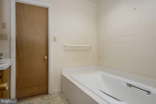 a view of a room with wooden floor and window