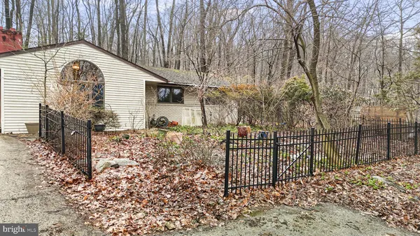 a view of a house with a small yard and wooden fence