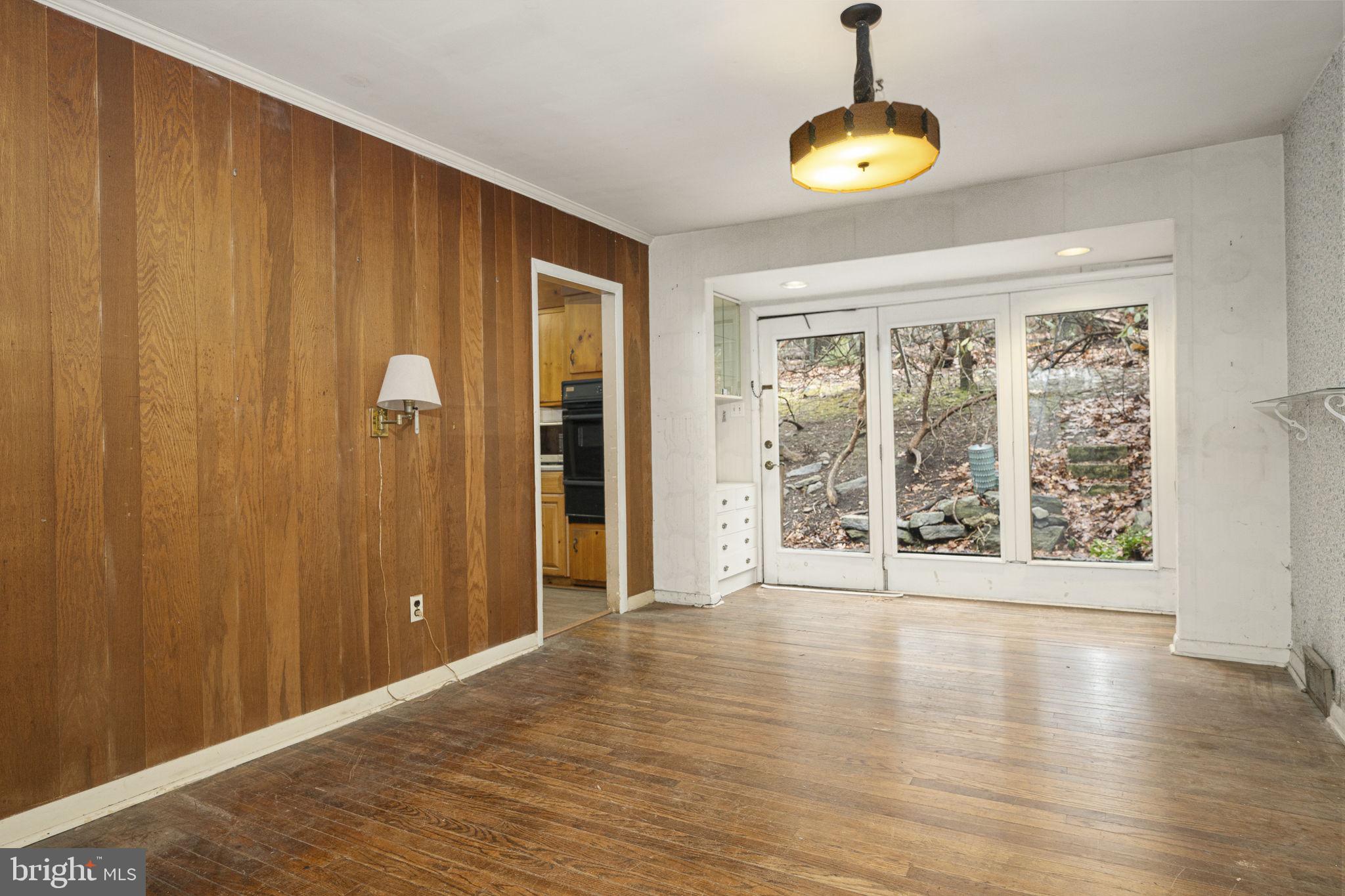 230 Jug Hollow Road Phoenixville, PA 19460 - Photo 6 of 60 a view of an empty room with wooden floor and a window