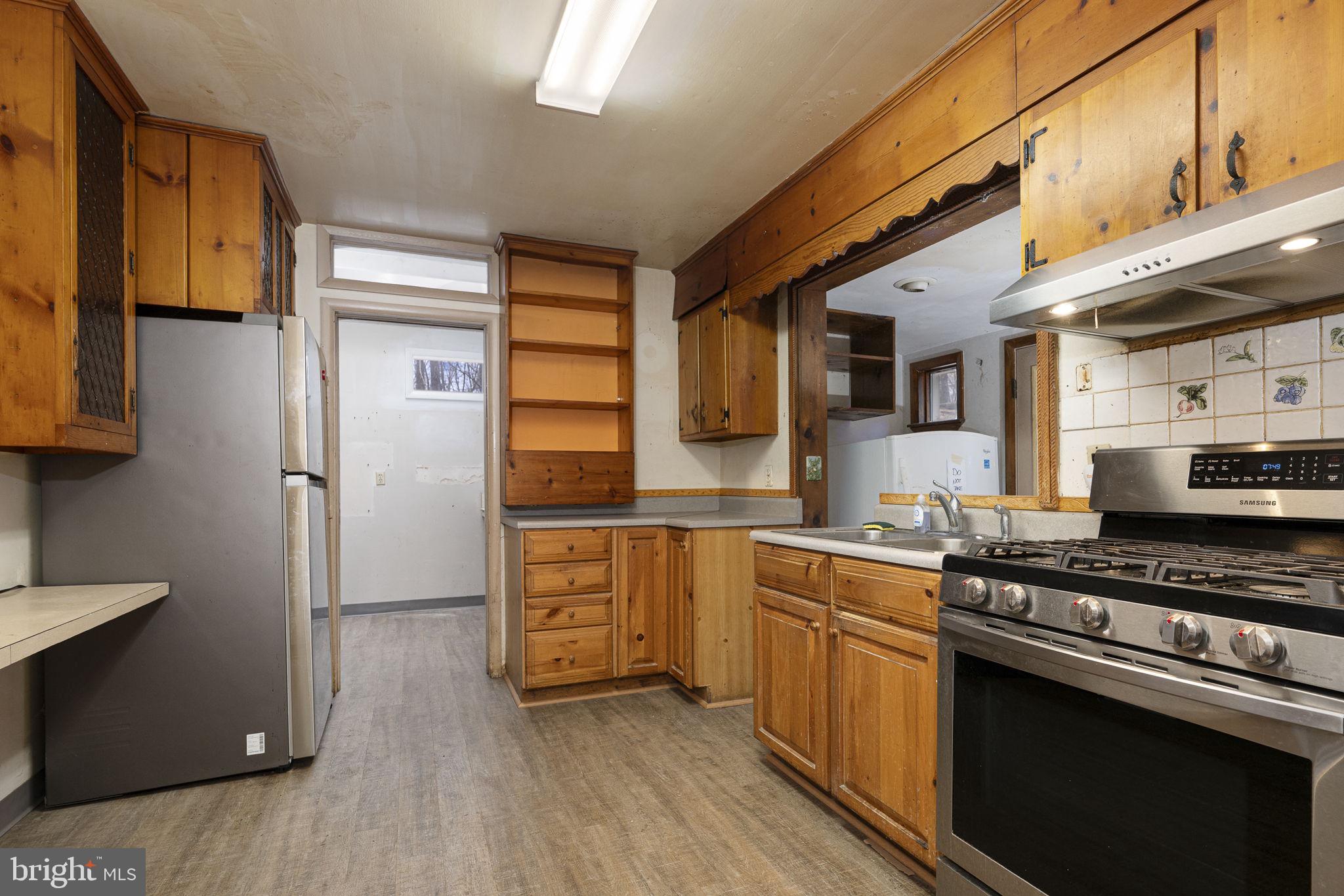 230 Jug Hollow Road Phoenixville, PA 19460 - Photo 8 of 60 a kitchen with stainless steel appliances a stove a sink and a refrigerator