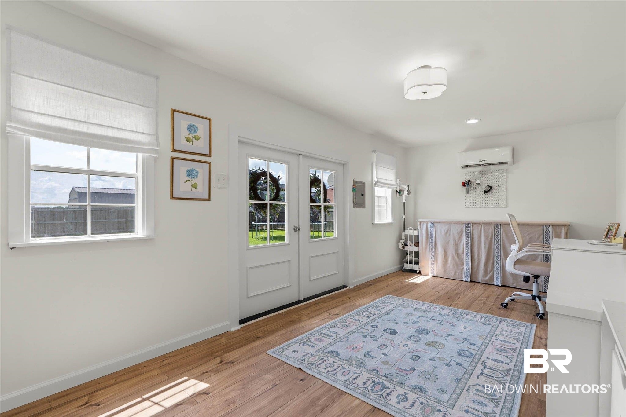 9074 Moses Way Theodore, AL 36582 - Photo 48 of 52 Versatile space featuring light wood-finish flooring, white walls, and double French doors with transom windows